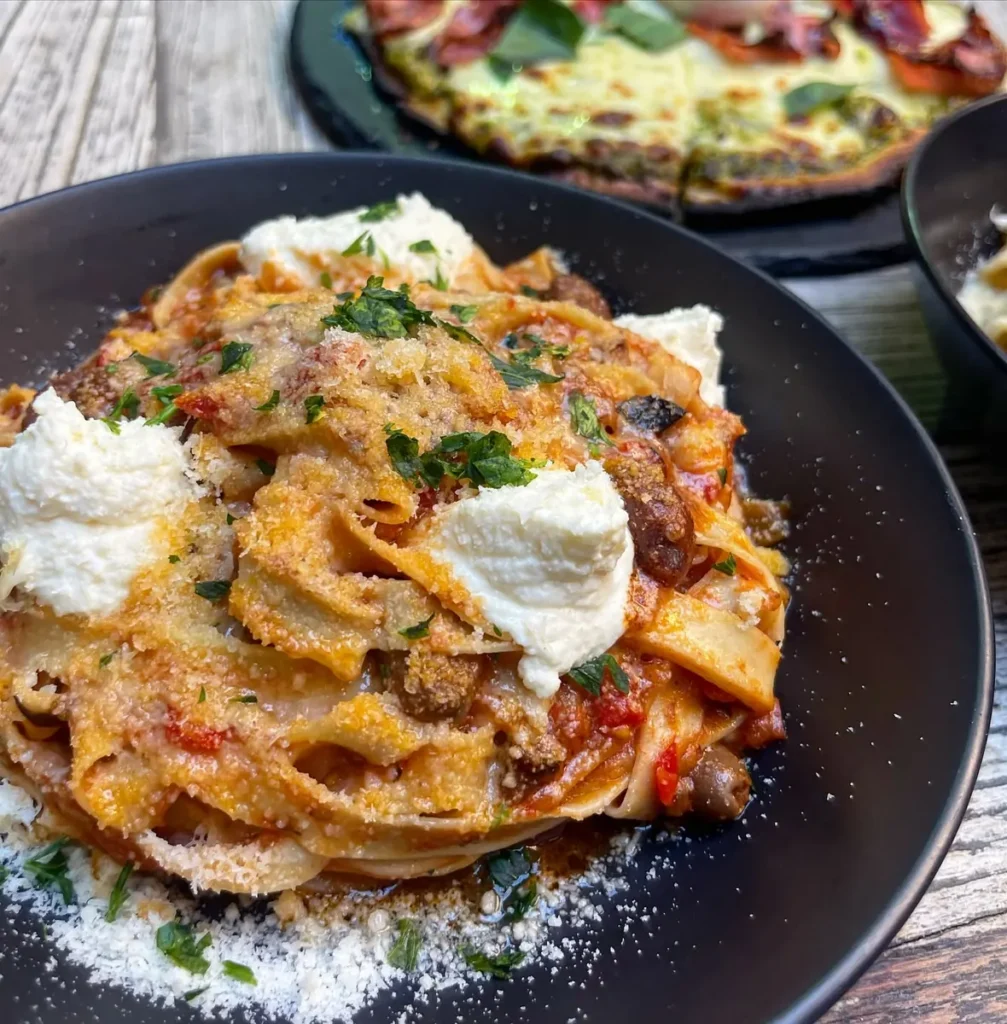 Pappardelle in tomato sugo topped with burrata
